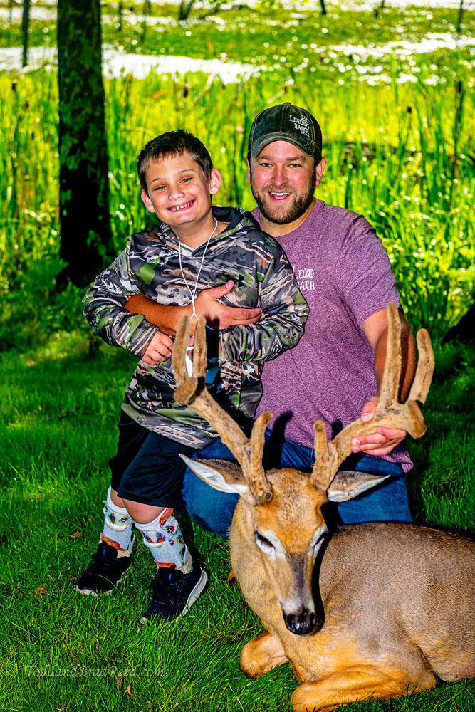 young hunter with deer