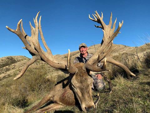 Hunter with red stag